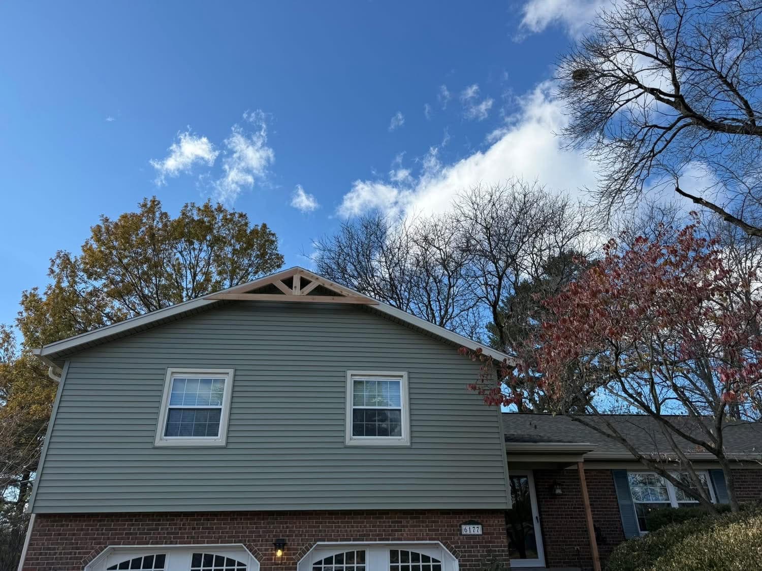 Sage green vinyl siding replacement on two story brick home by 937 Precision in Dayton Ohio